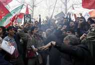 Iranian men shout slogans during a demonstration in front of the Austrian embassy in Tehran February 6, 2006. A crowd of about 200 people pelted the Austrian Embassy in Tehran with petrol bombs and stones on Monday in a protest over the publication of cartoons depicting the Prophet Mohammad.    