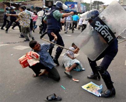 Riot police with baton charge activists of Bangladesh main opposition  Awami League during a demonstration to protest a weekend grenade attack on a political rally that killed 19 people and wounded hundreds, in Dhaka, Bangladesh, Monday, Aug. 23, 2004. (AP Photo/Pavel Rahman)